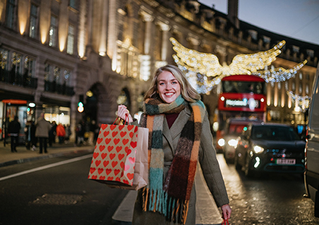 A vibrant image of the bustling streets of Oxford Circus, showcasing shoppers and iconic stores.